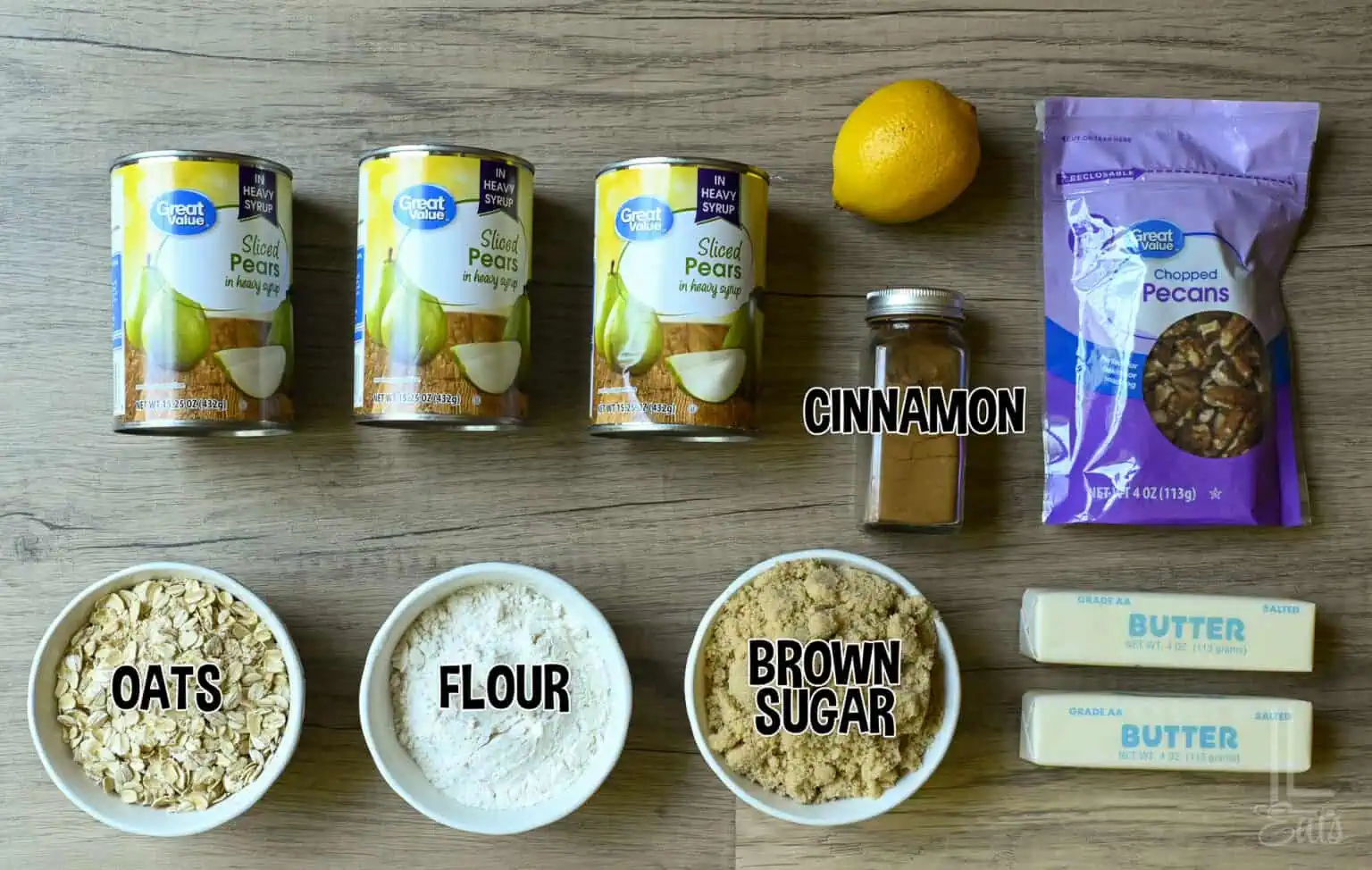 Ingredients for pear crumble with canned pears, oats, flour, brown sugar, cinnamon, and butter.