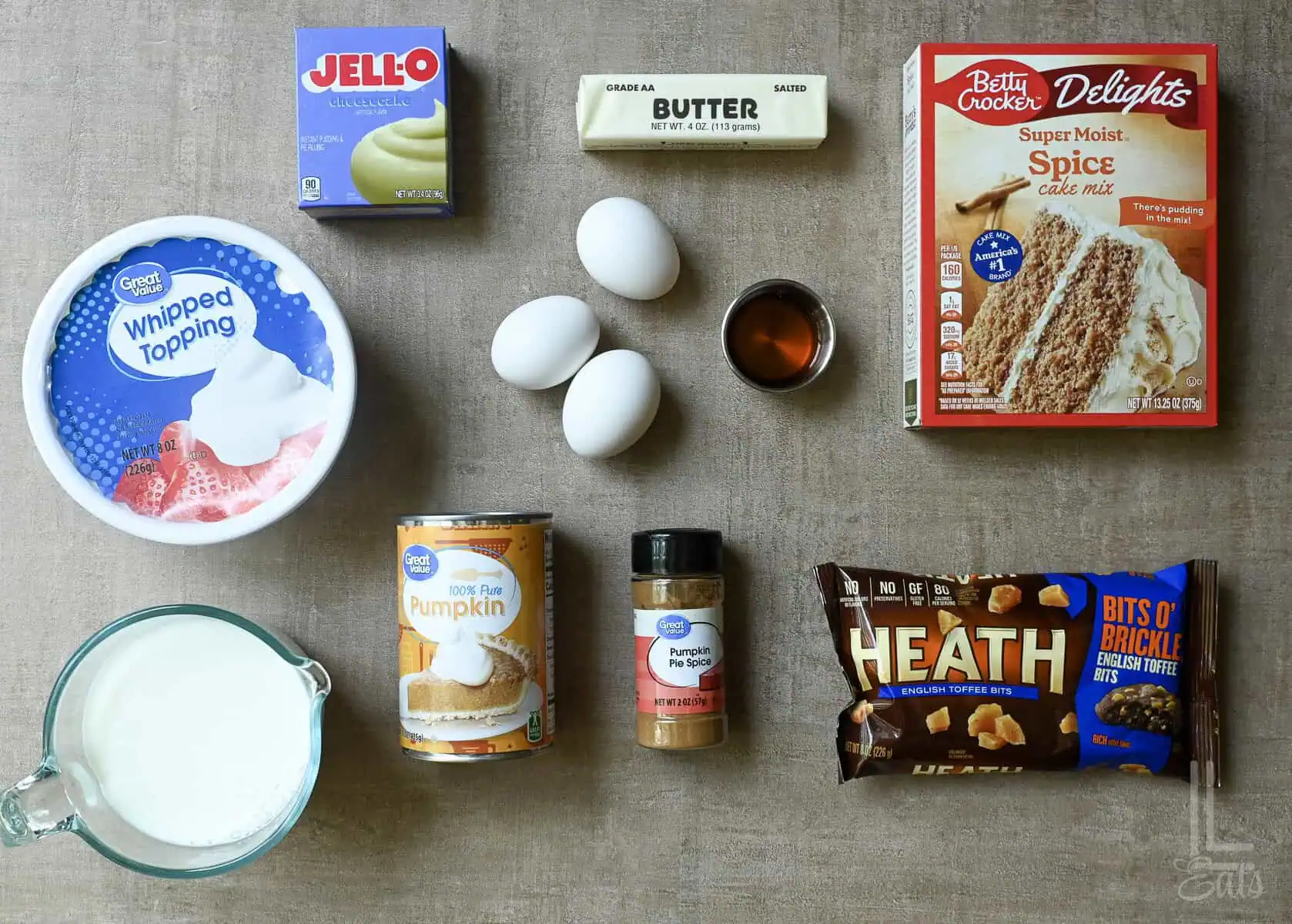Ingredients for Pumpkin Poke Cake including eggs, butter, pudding mix, and spice cake mix.