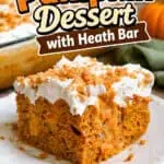 Pumpkin poke cake with Heath bar topping and creamy frosting on a white plate.