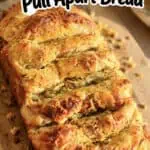Close-up of cheesy garlic pull apart bread with golden crust and melted cheese.