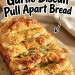 Close-up of cheesy garlic pull apart bread with golden crust and melted cheese.