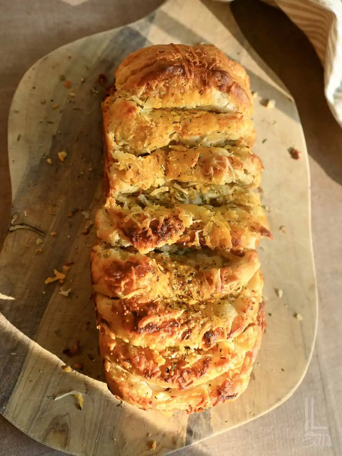 Cheesy garlic pull apart bread with golden crust and gooey cheese inside.
