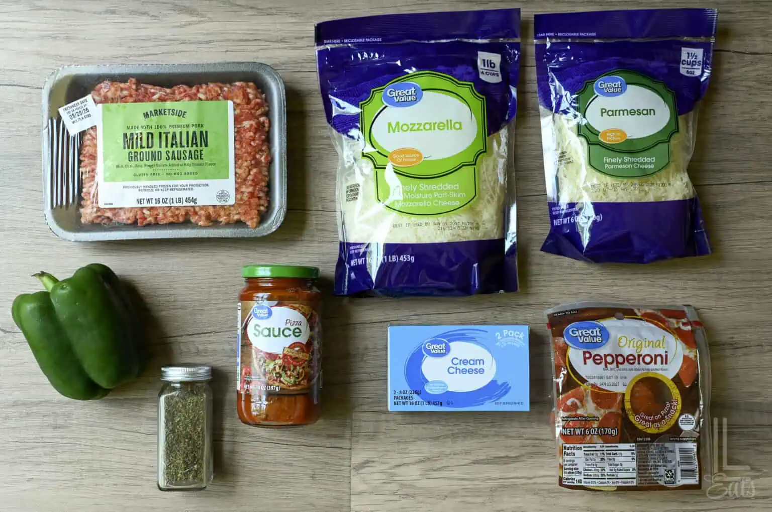 Ingredients for Crock Pot Pizza Dip including ground Italian sausage, cheeses, and peppers.