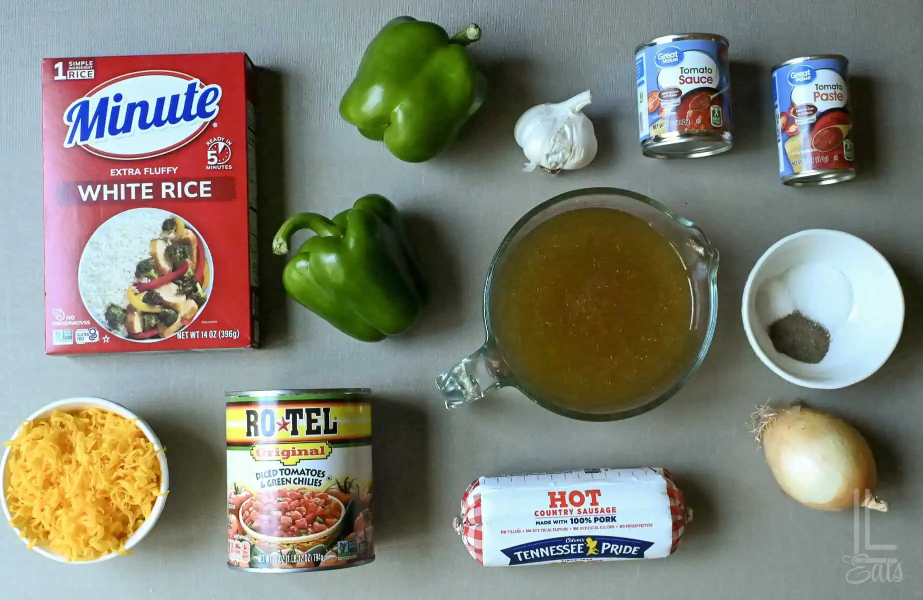 Ingredients for stuffed pepper soup including rice, green peppers, garlic, canned tomatoes, and broth.