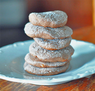 stack of chocolate peanut butter cookies on a white plate.